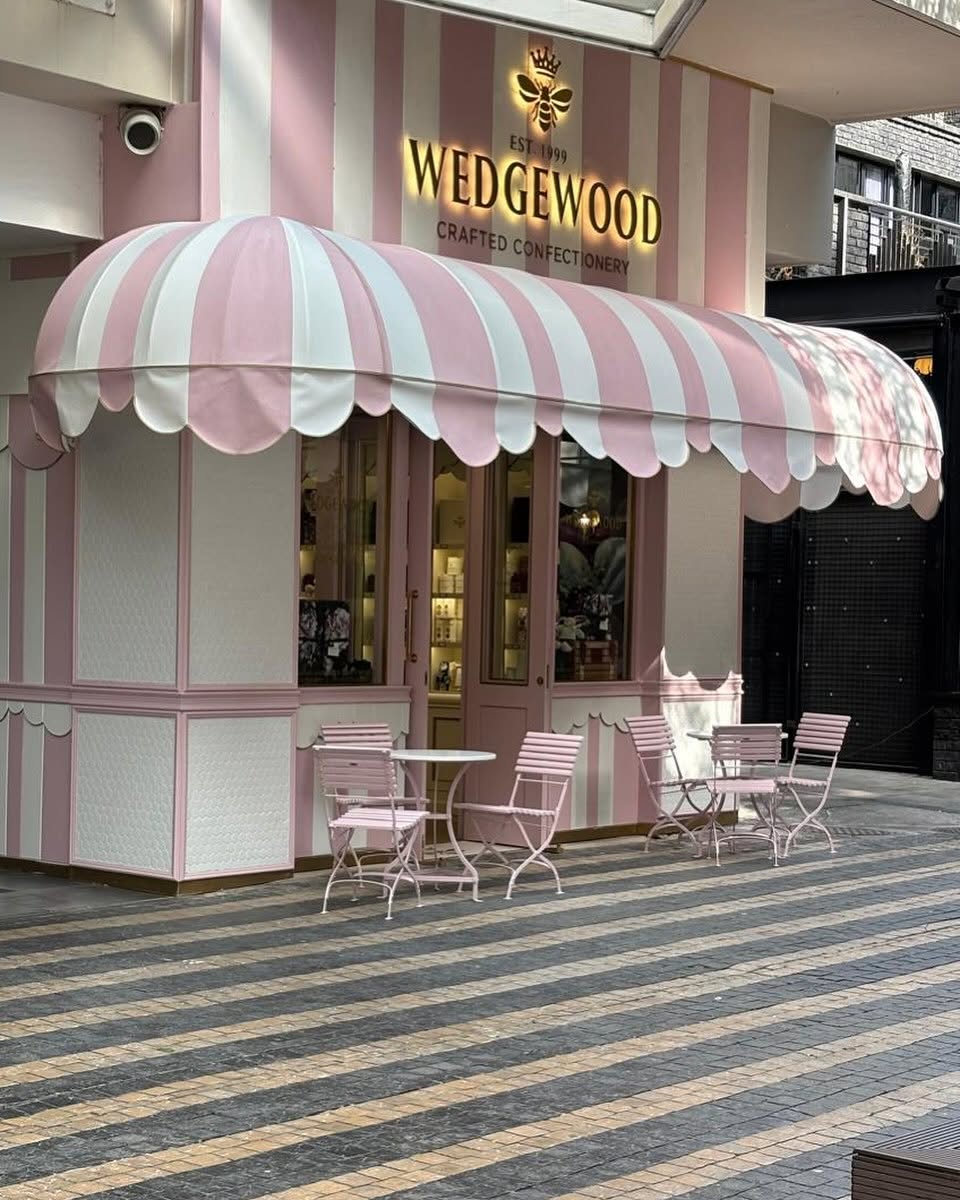 Pink and white striped canvas shopfront awning by Exclusive & Ideal Awnings